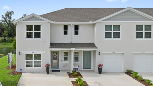 Attached townhome with concrete block construction and a one-car garage.