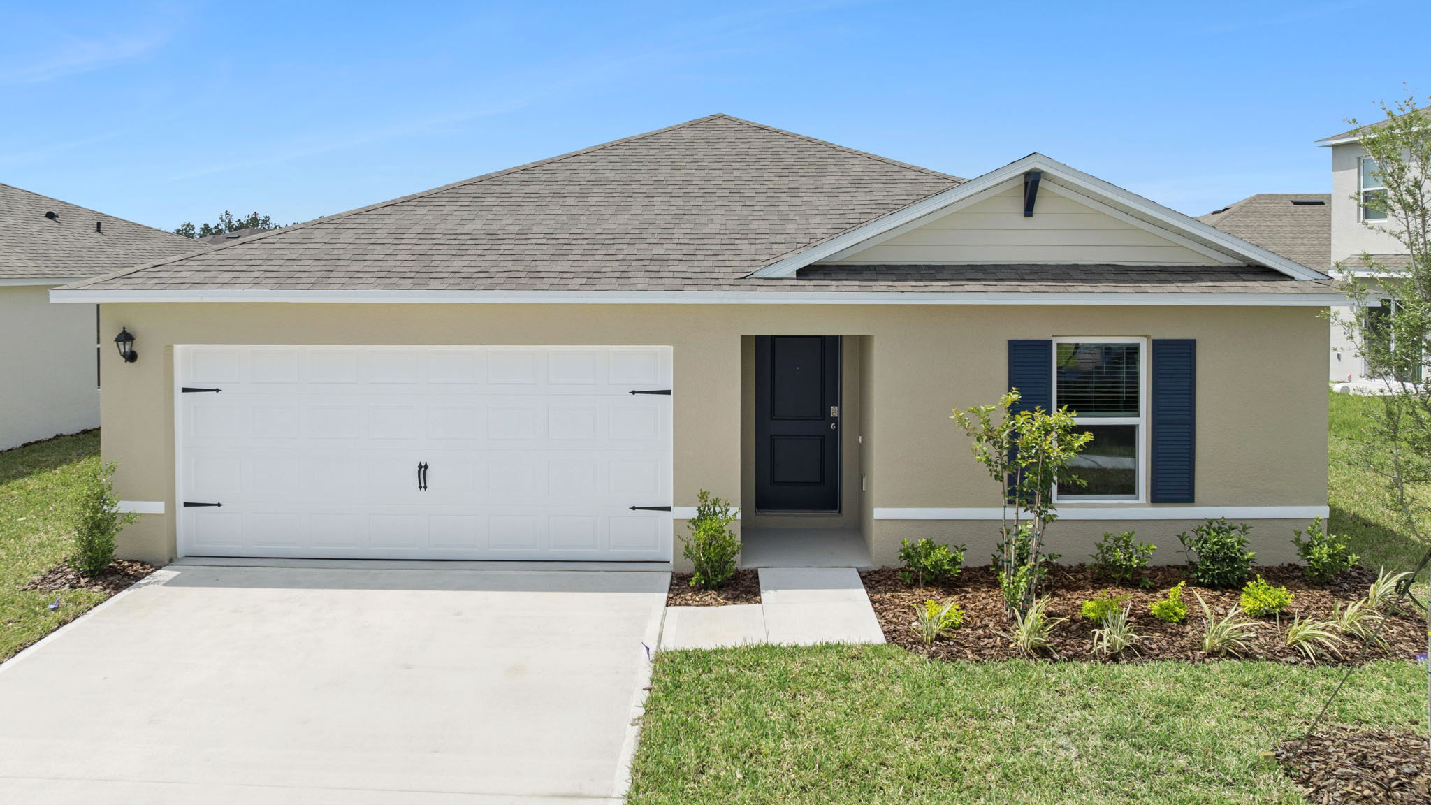 Single story new home with large windows and 2 car garage.