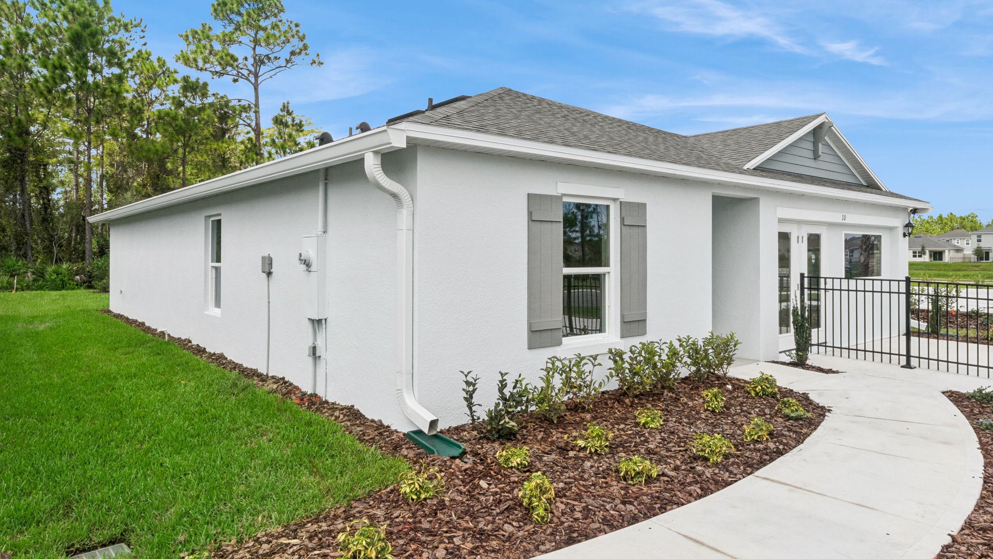 Single story new home with large windows and 2 car garage.