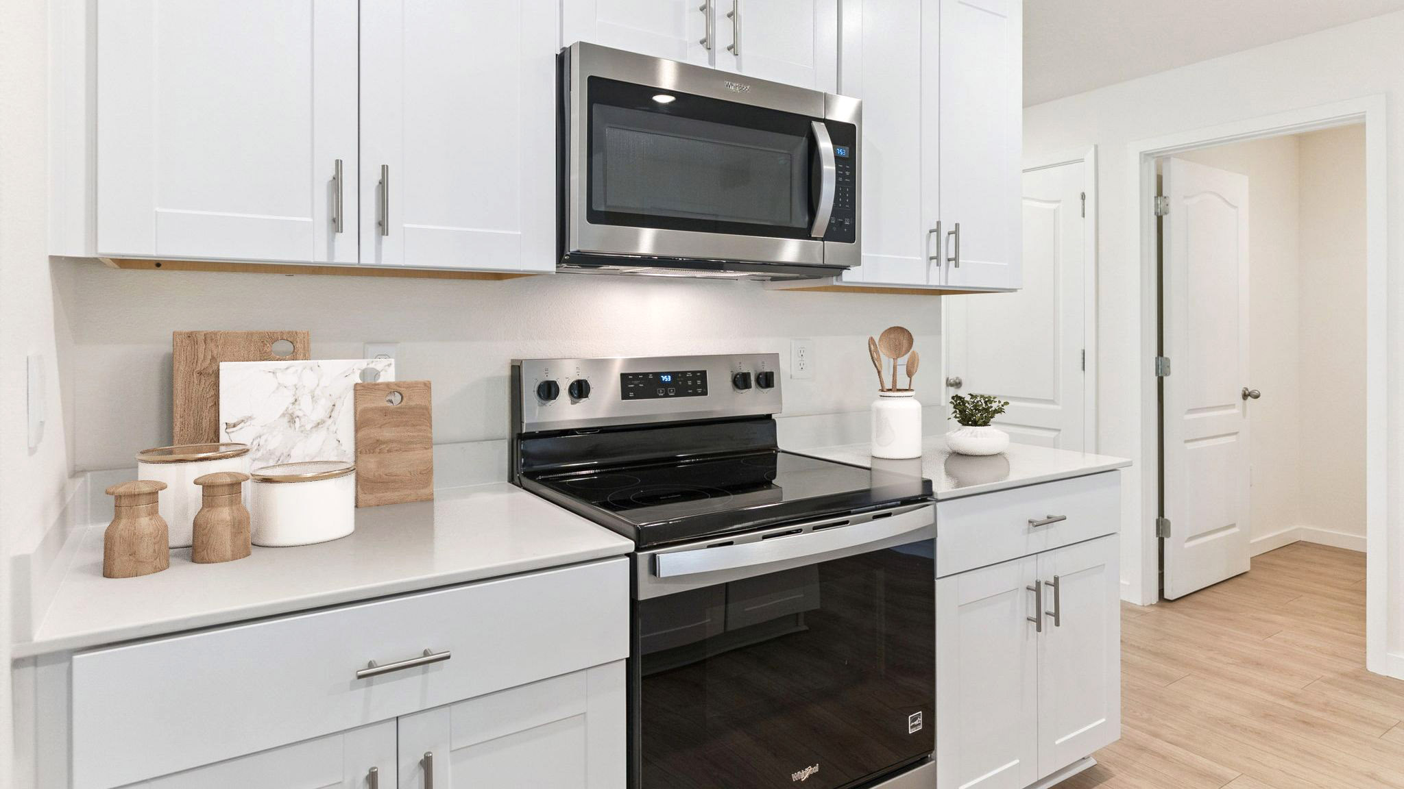 kitchen with quartz countertops overseeing living area and dining room table