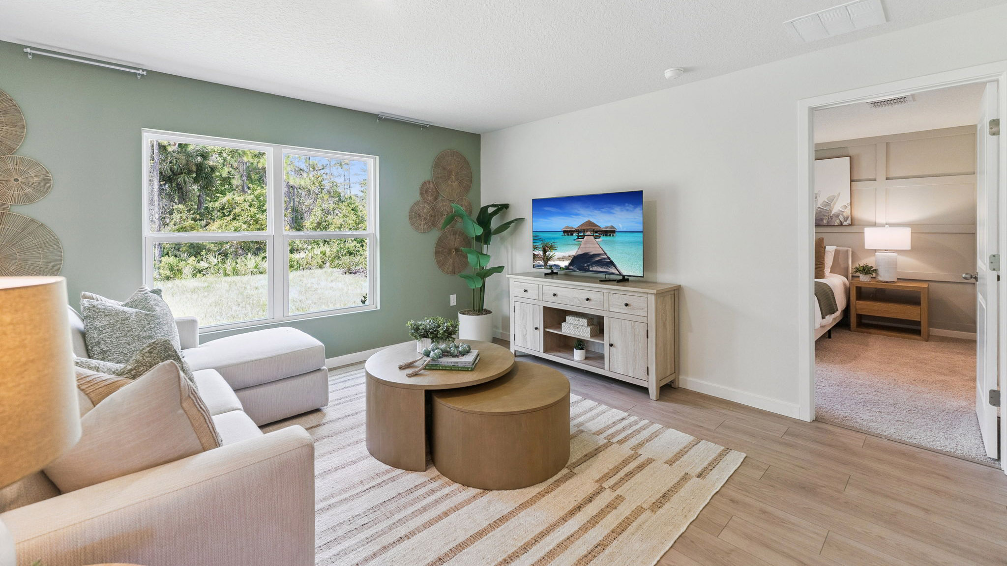 Living area with couch seating, entertainment system and natural lighting