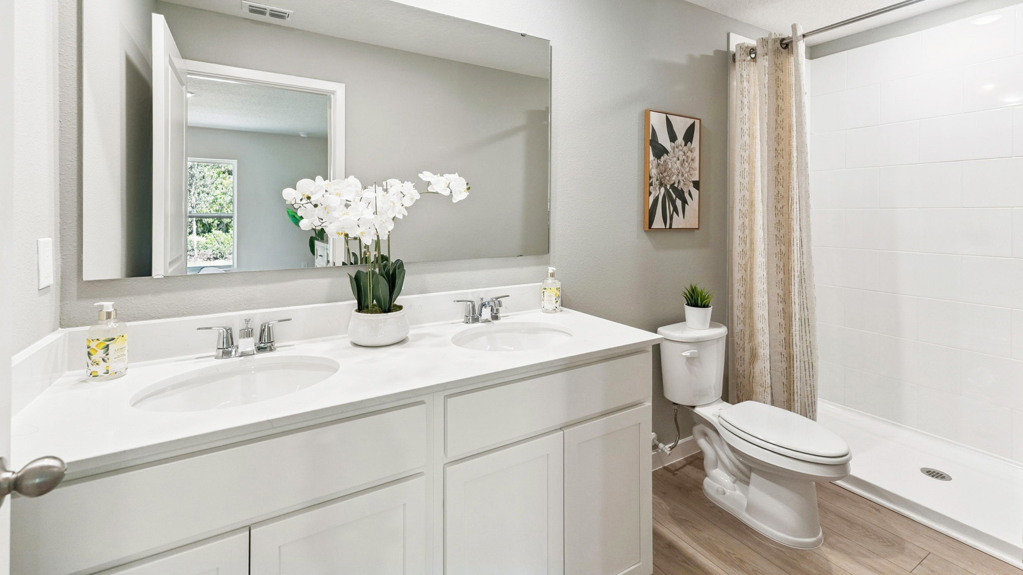 Guest bathroom with single vanity quartz countertops, toilet and shower.