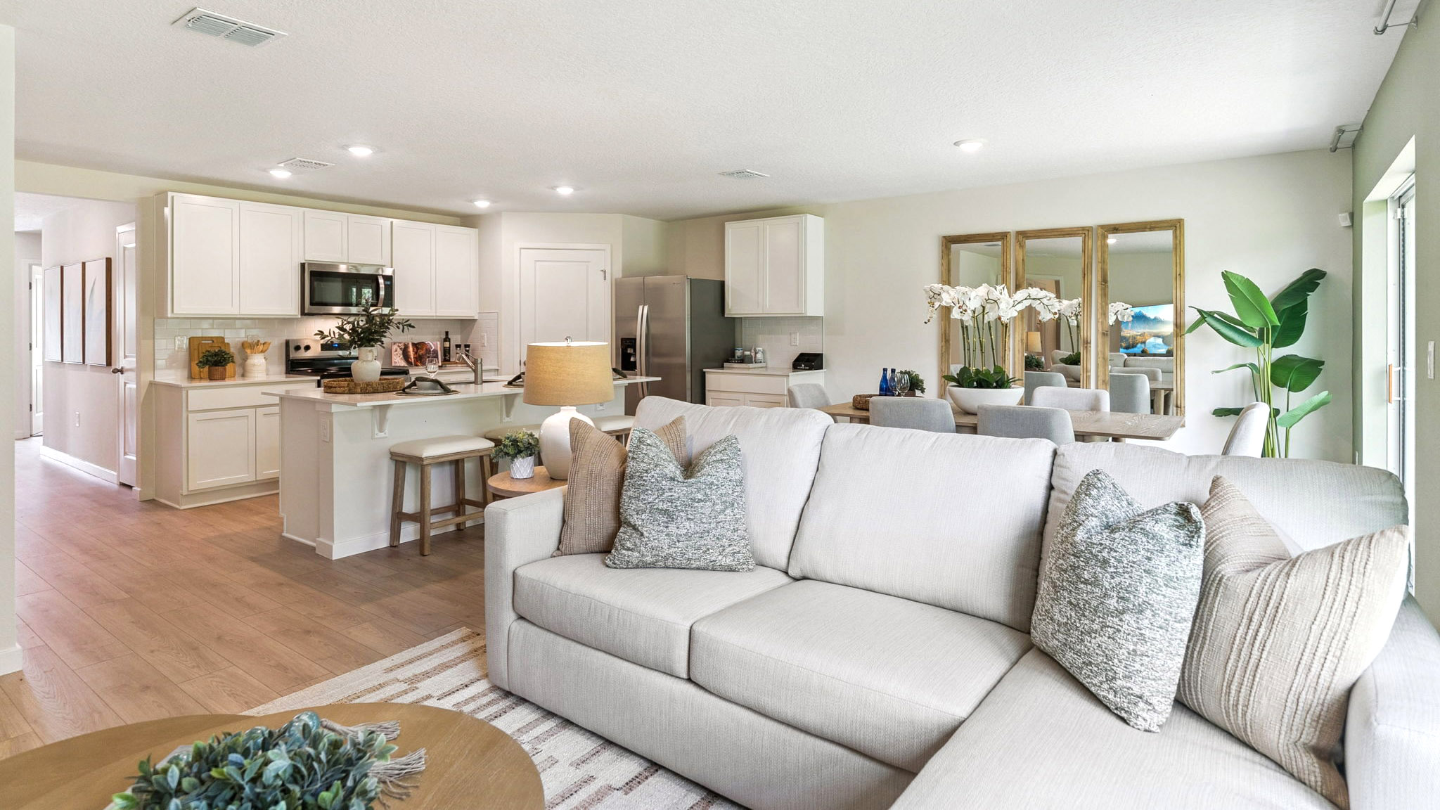 Living area with couch seating, entertainment system and natural lighting