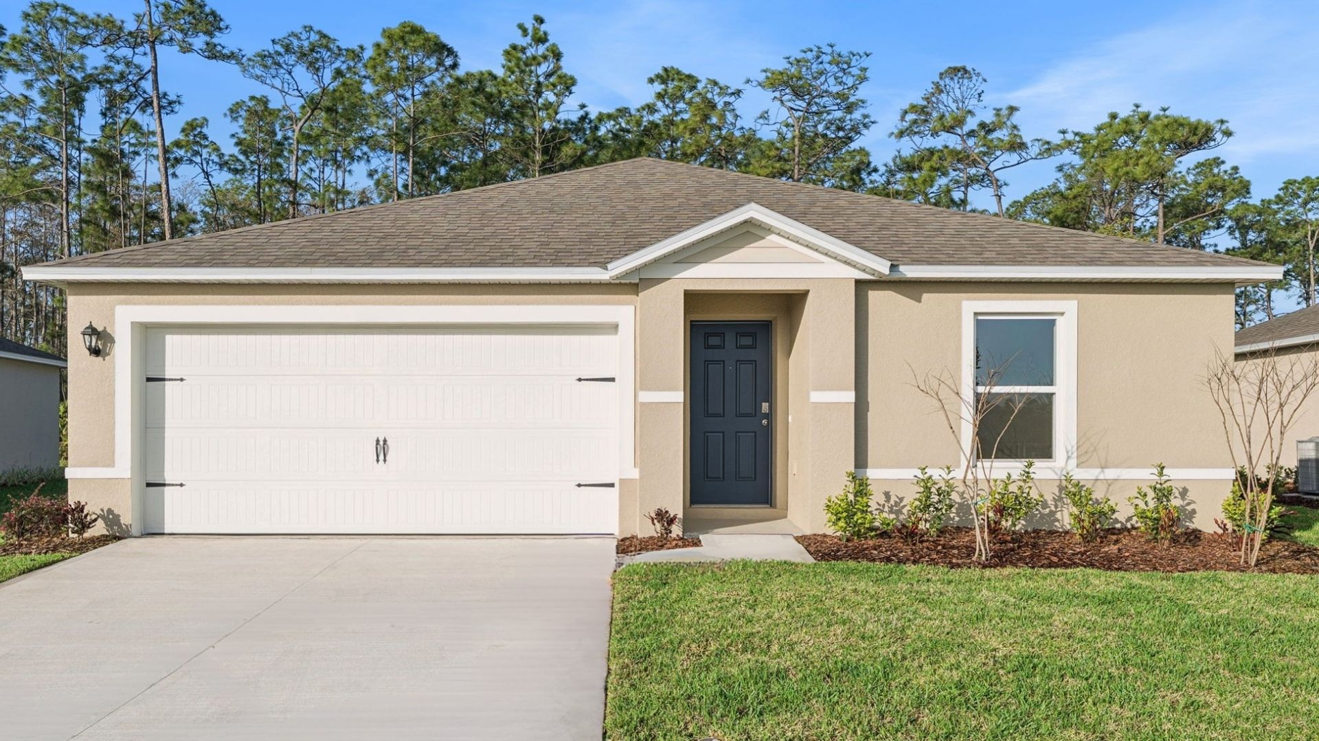 Single story new home with large windows and 2 car garage.