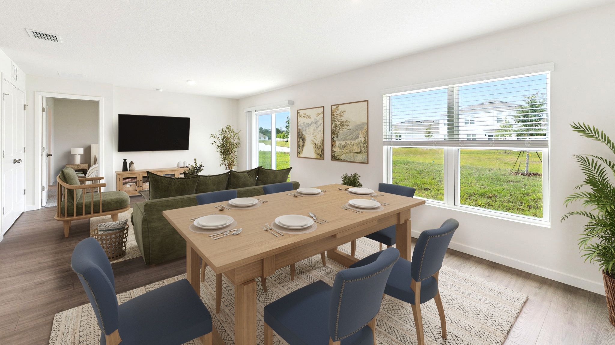Dining room area with table, seating and natural lighting.