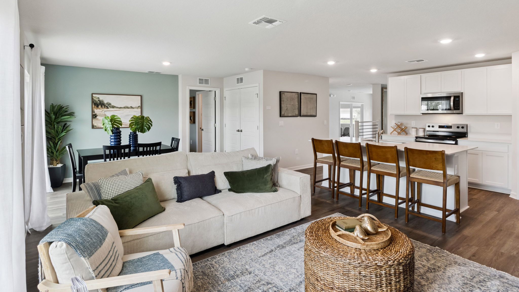 Living area with couch seating, natural lighting, luxury vinyl plank flooring.