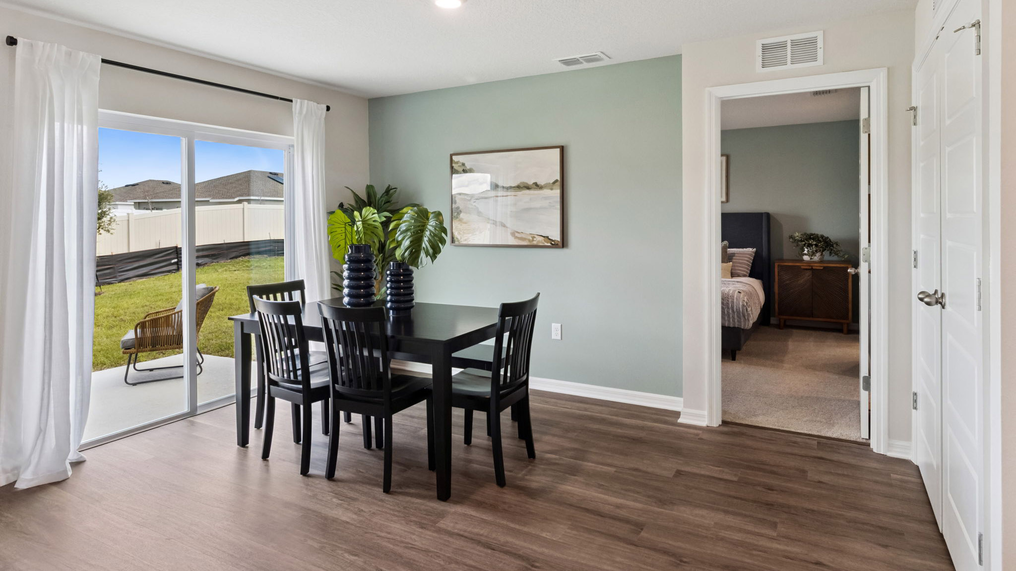 Dining room area with table, seating and natural lighting.