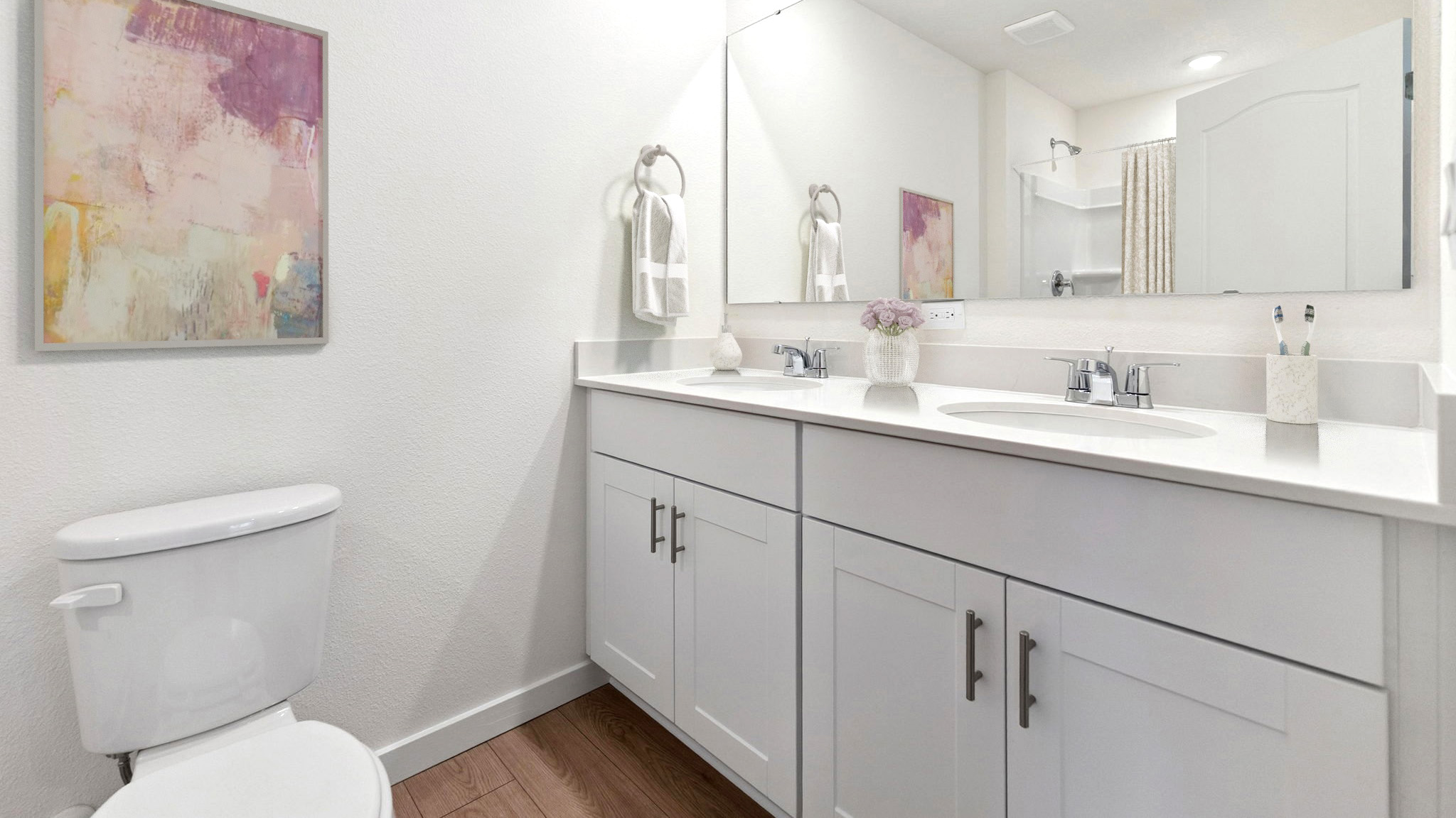 primary bathroom with quartz counters double sink and revwood select flooring