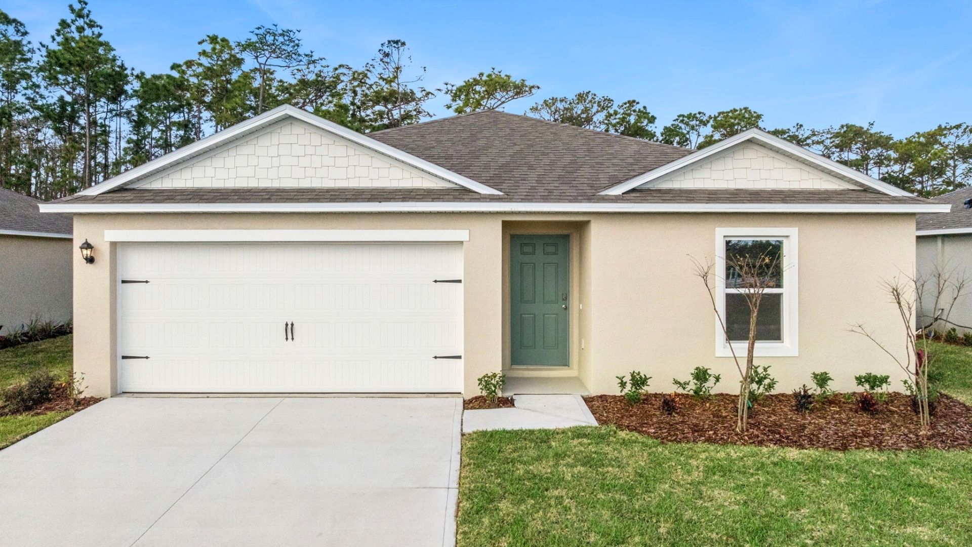 Single story new home with large windows and 2 car garage.
