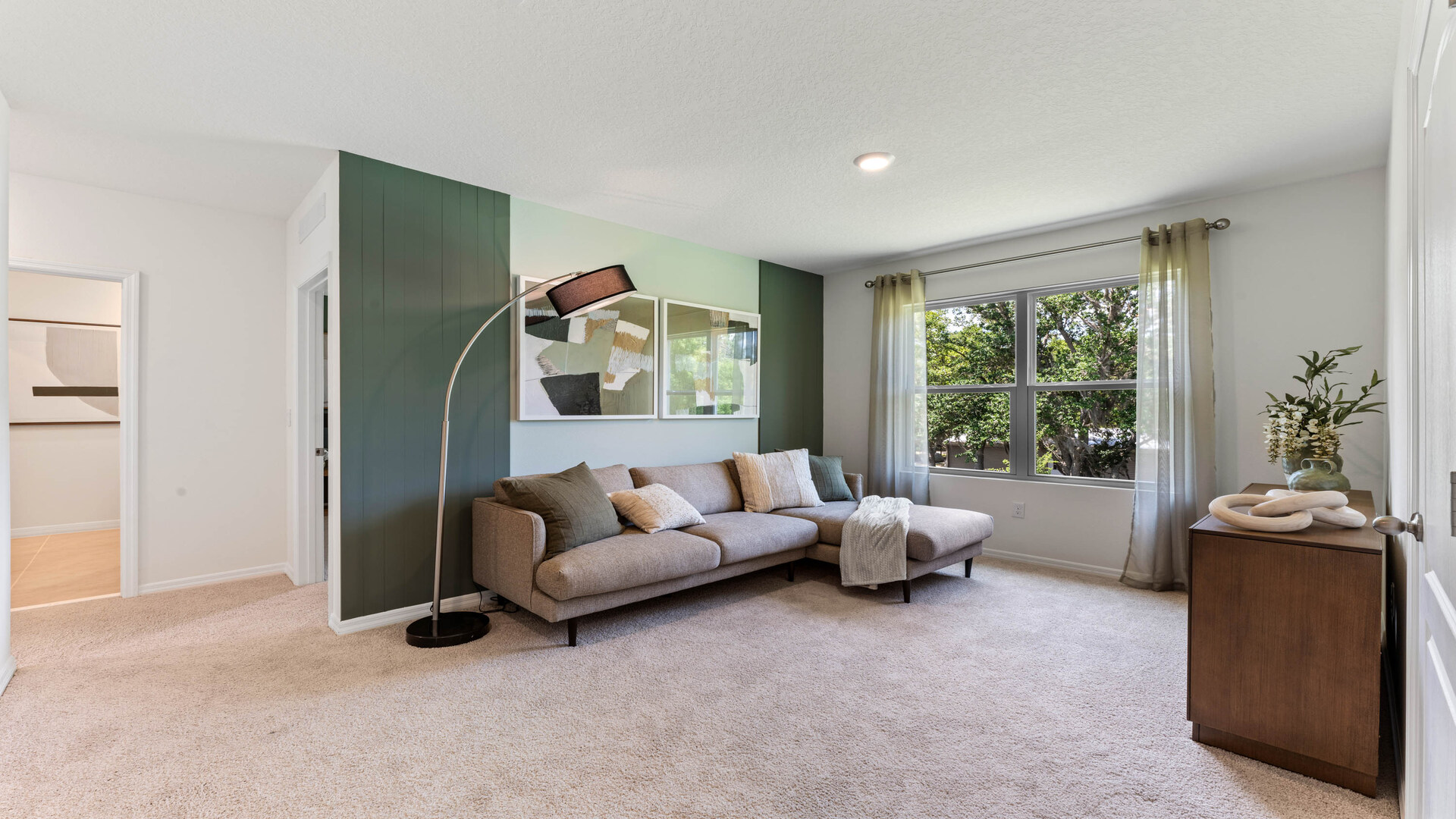 Child's nursery with crib, closet, soft seating and storage.