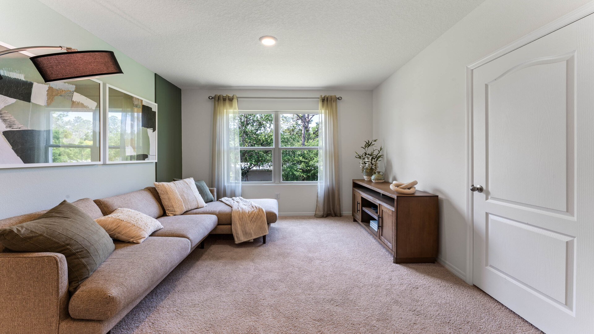 Child's nursery with crib, closet, soft seating and storage.