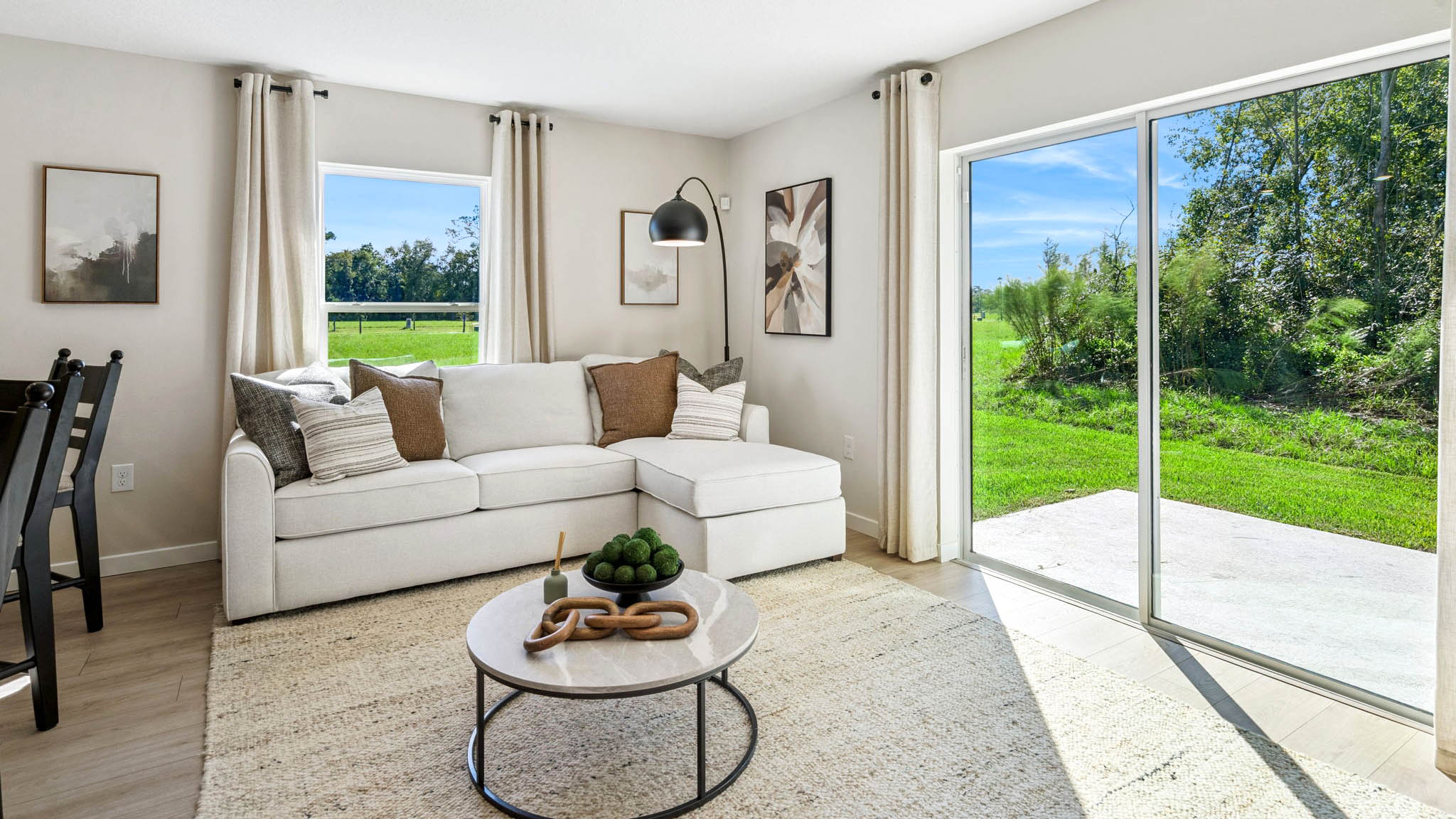 Living area with couch seating, entertainment system and natural lighting
