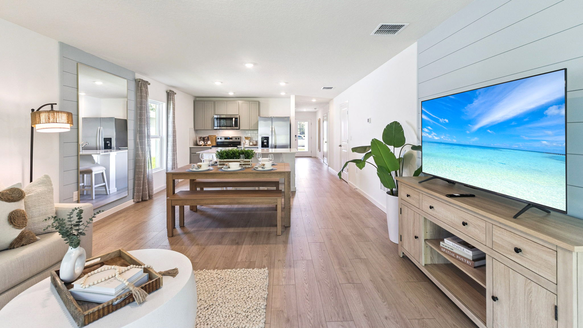 Living area with couch seating, entertainment system and natural lighting