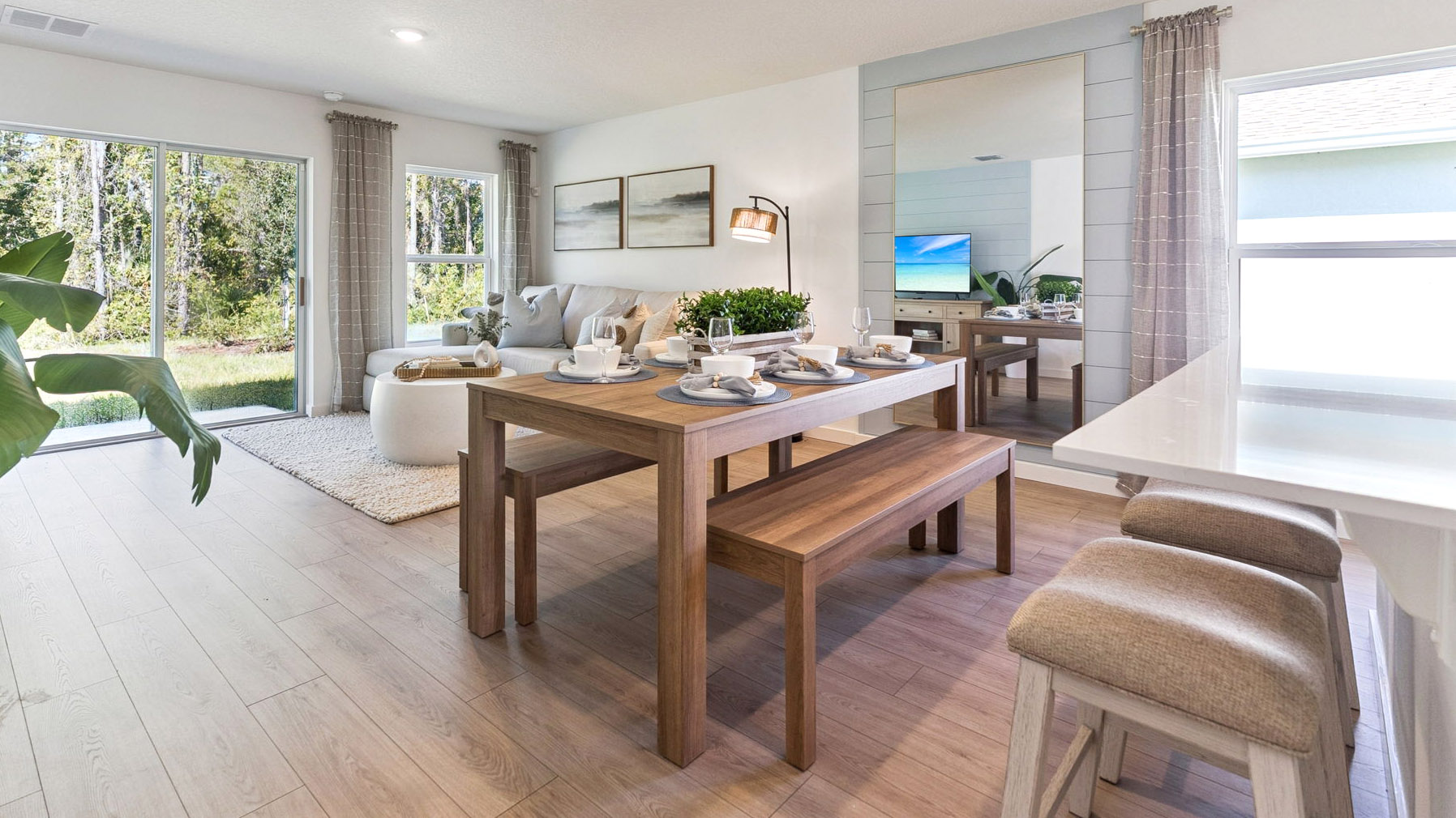 Living area with couch seating, entertainment system and natural lighting