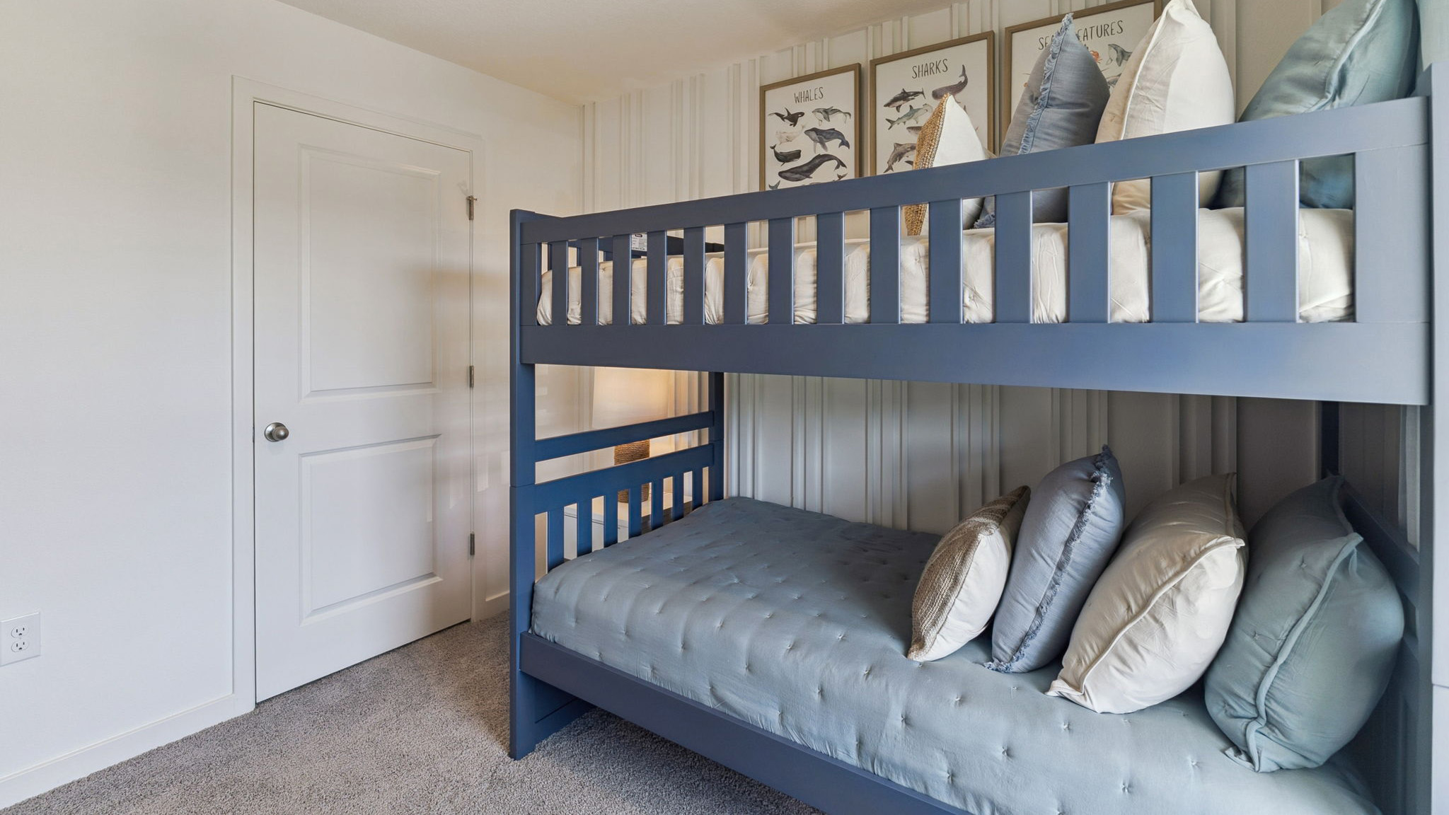 Spacious primary bedroom with king size bed, carpet flooring, natural lighting.