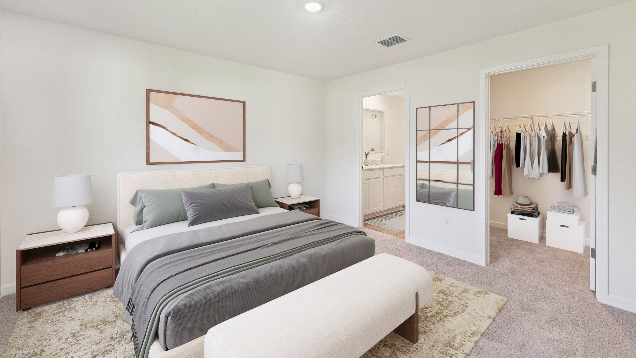 Spacious primary bedroom with king size bed, carpet flooring, natural lighting.