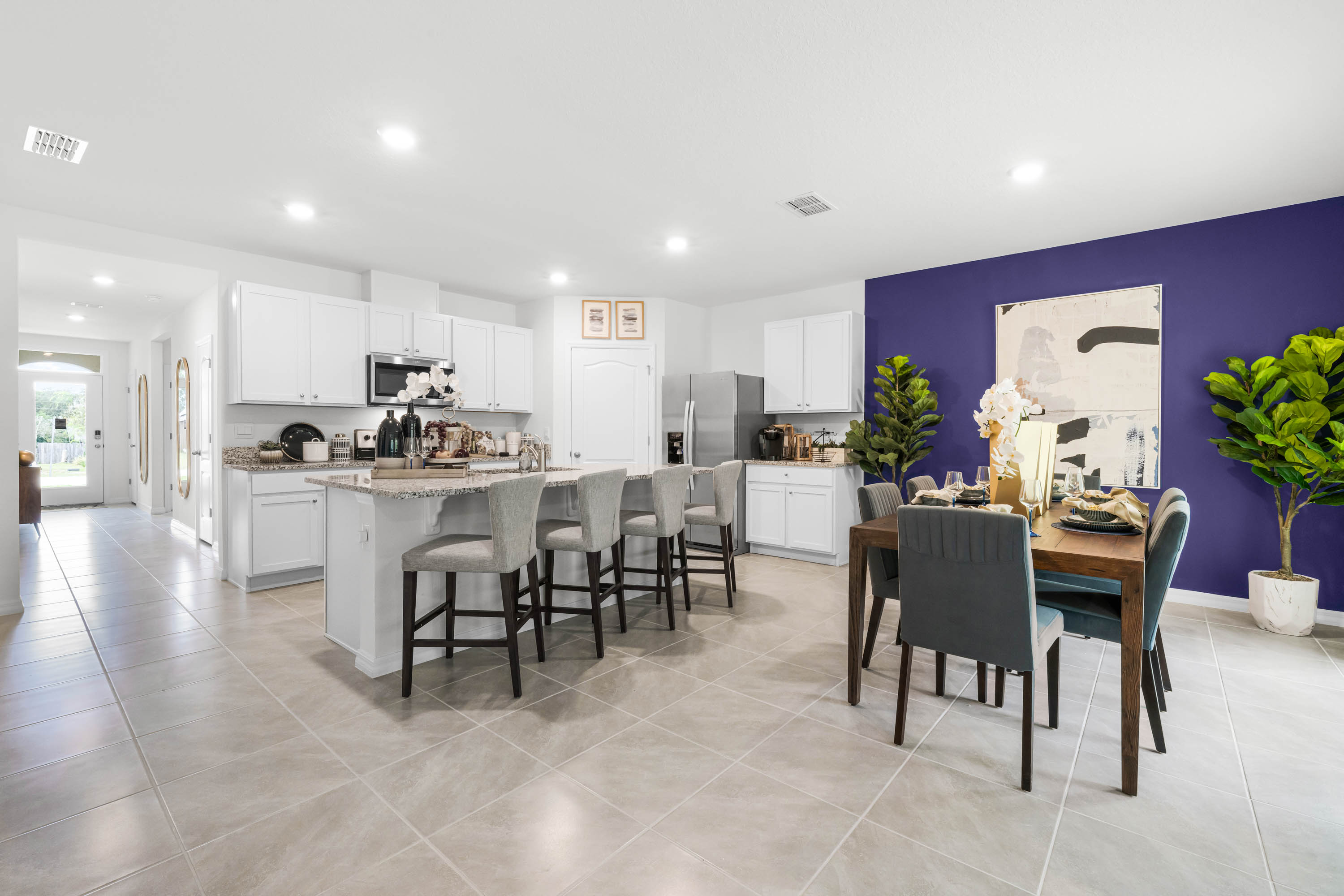 Shows both the dining and kitchen area together.