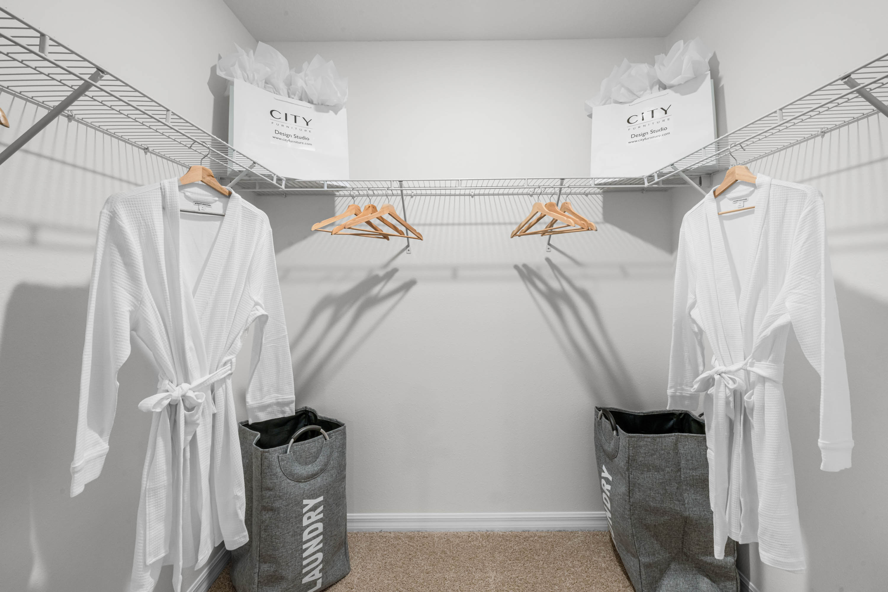 Spacious walk in closet with abundant shelving and storage.