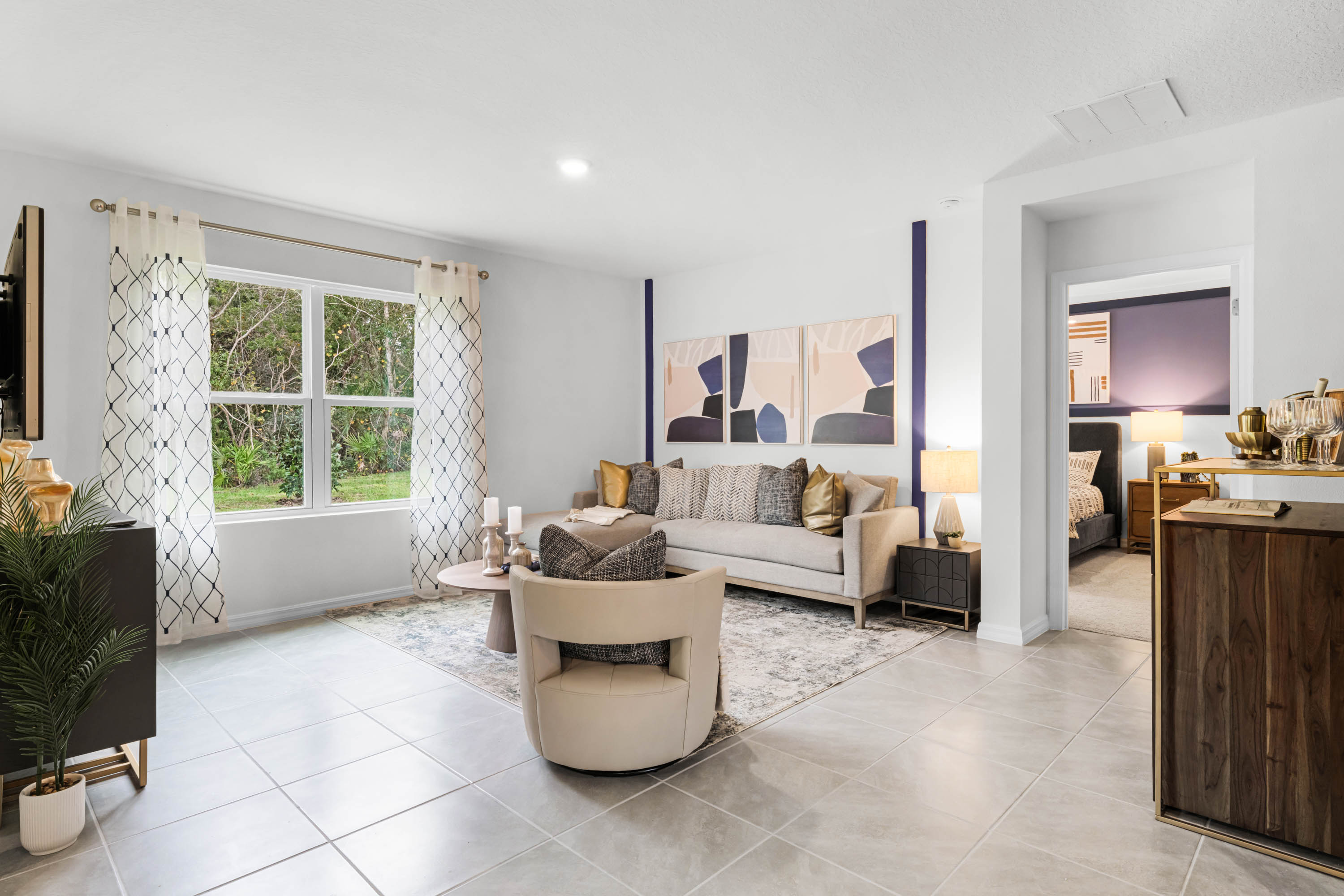 Open concept living area with couch seating and access to the backyard thru slider door.