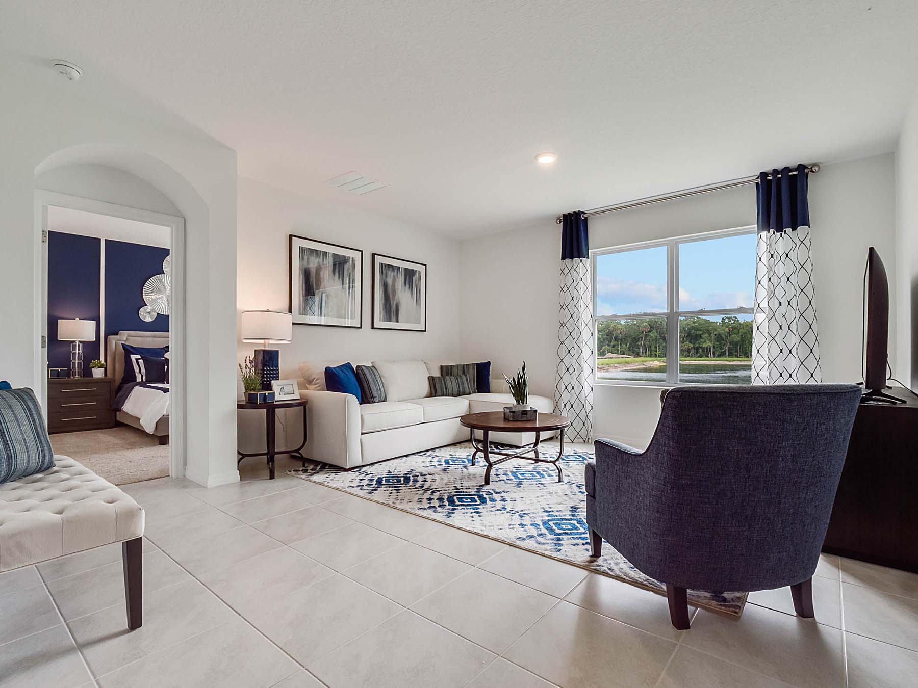 Open concept living area with couch seating and access to the backyard thru slider door.