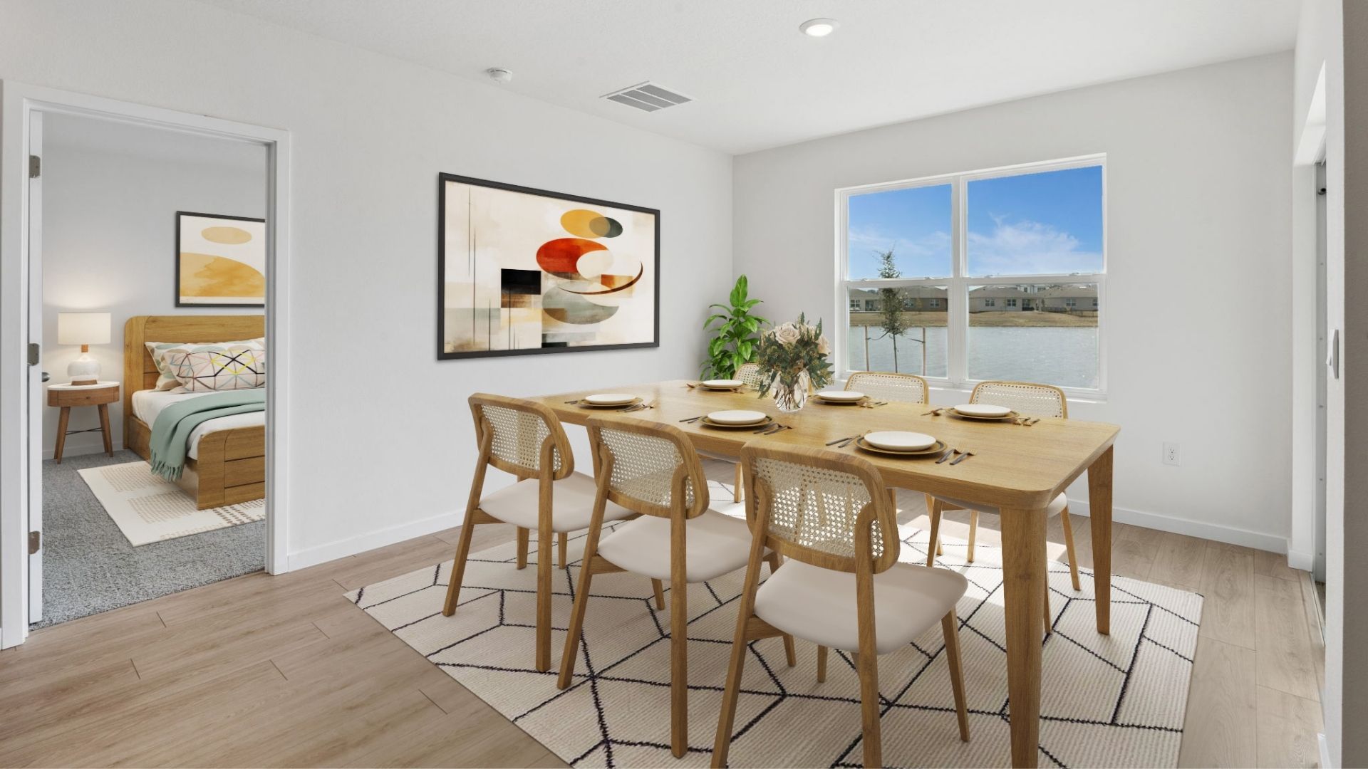 Spacious primary bedroom with king size bed, carpet flooring, natural lighting.