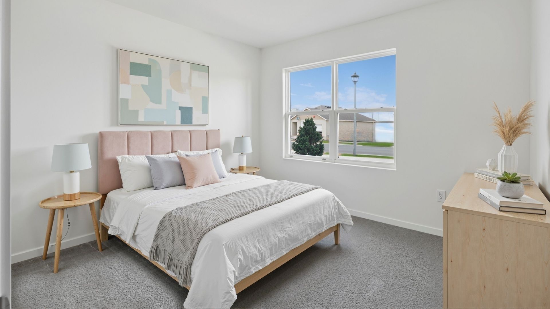 Guest bedroom with bed, nighstand, desk, and natural lighting with spacious closet.