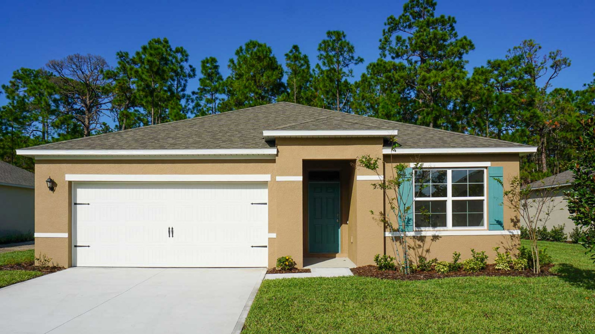 Single story new home with large windows and 2 car garage.