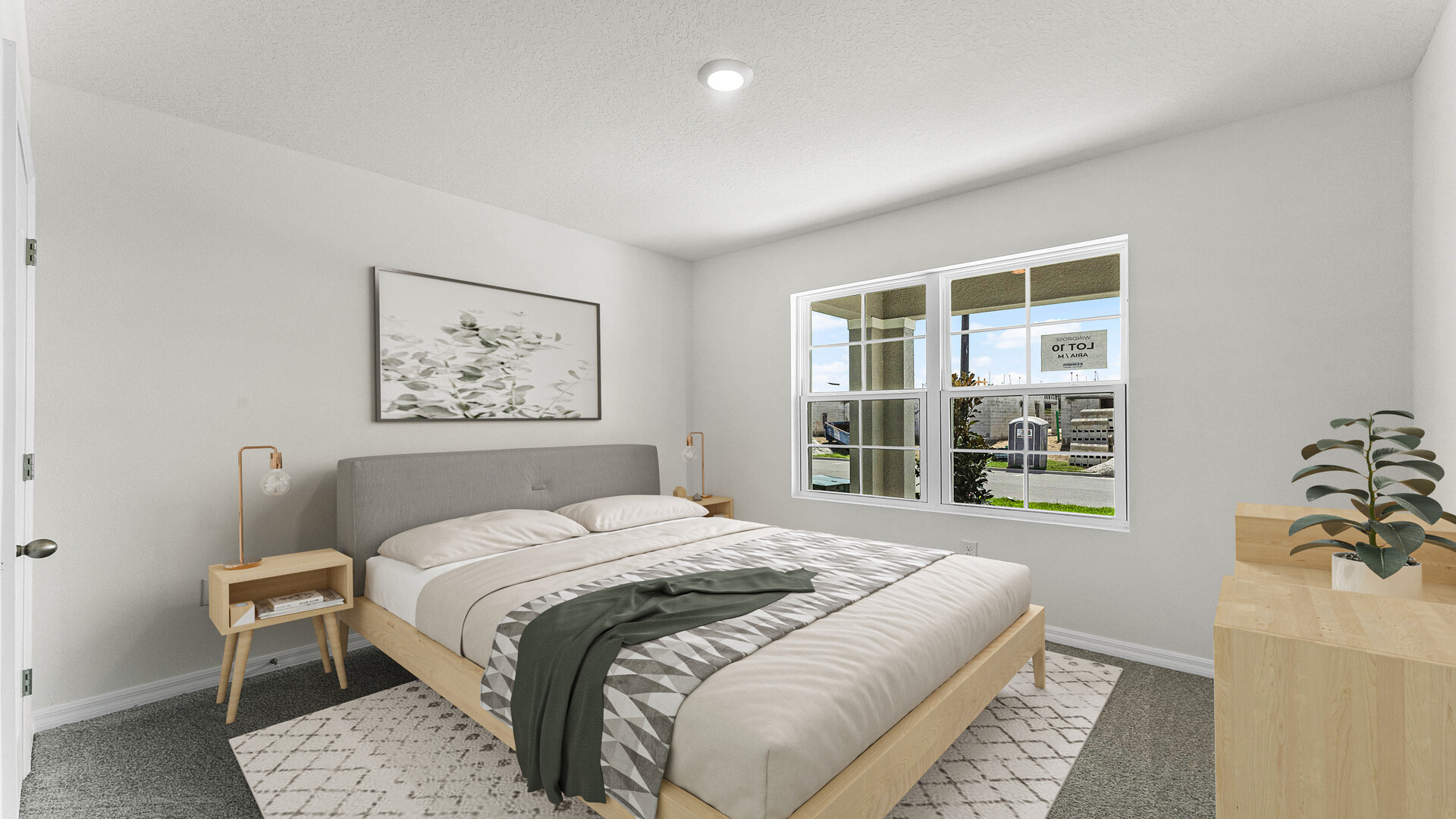 Guest bedroom with bed, nighstand, desk, and natural lighting with spacious closet.