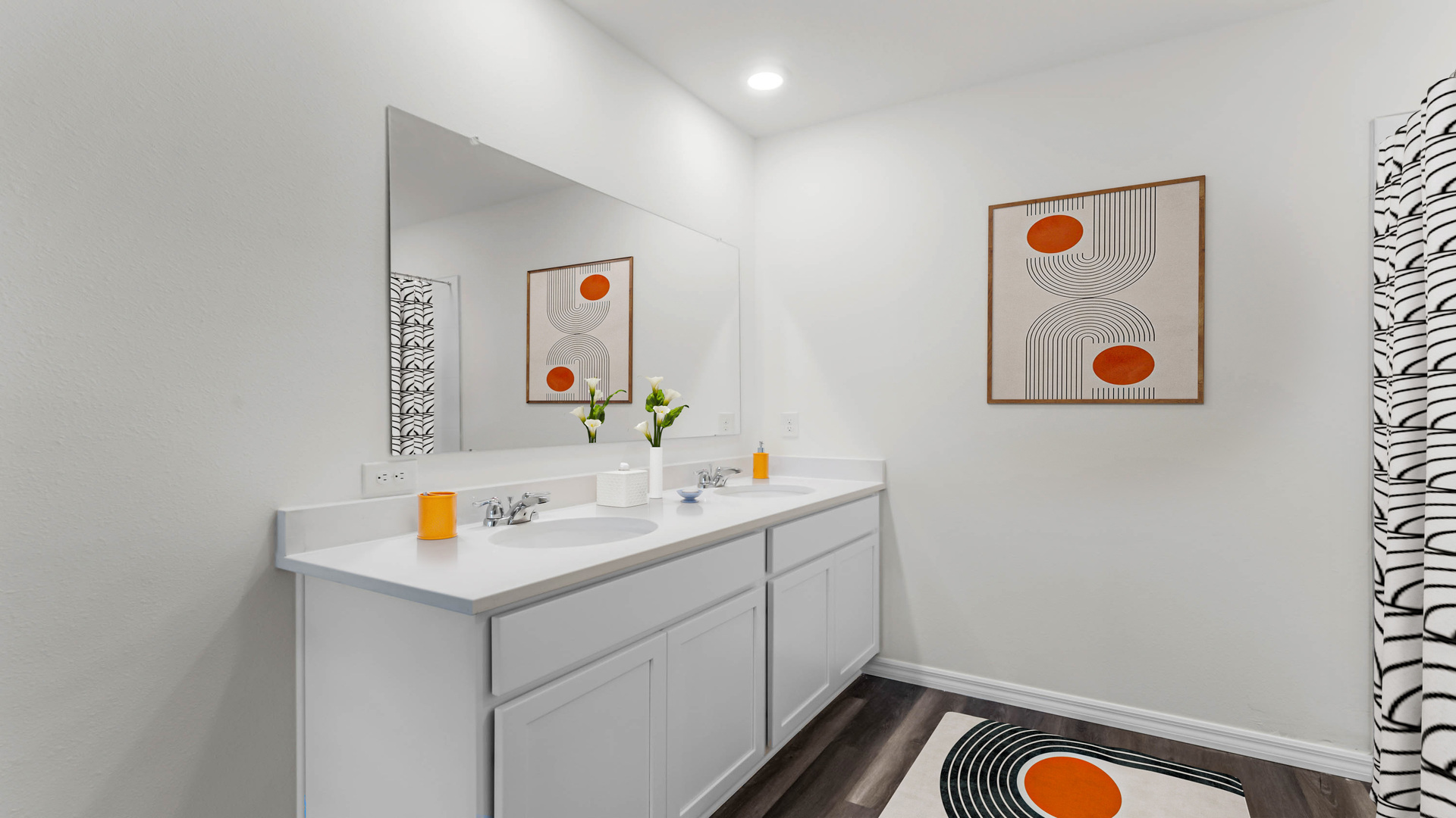 Guest bedroom with bed, nighstand, desk, and natural lighting with spacious closet.