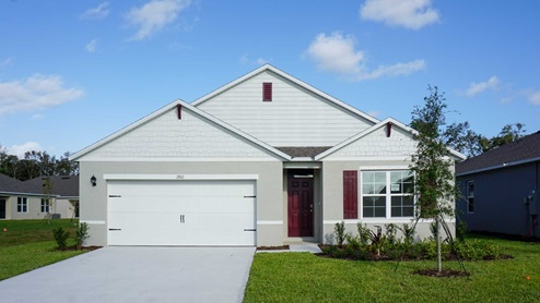 Single story new home with siding, covered porch and 2 car garage.