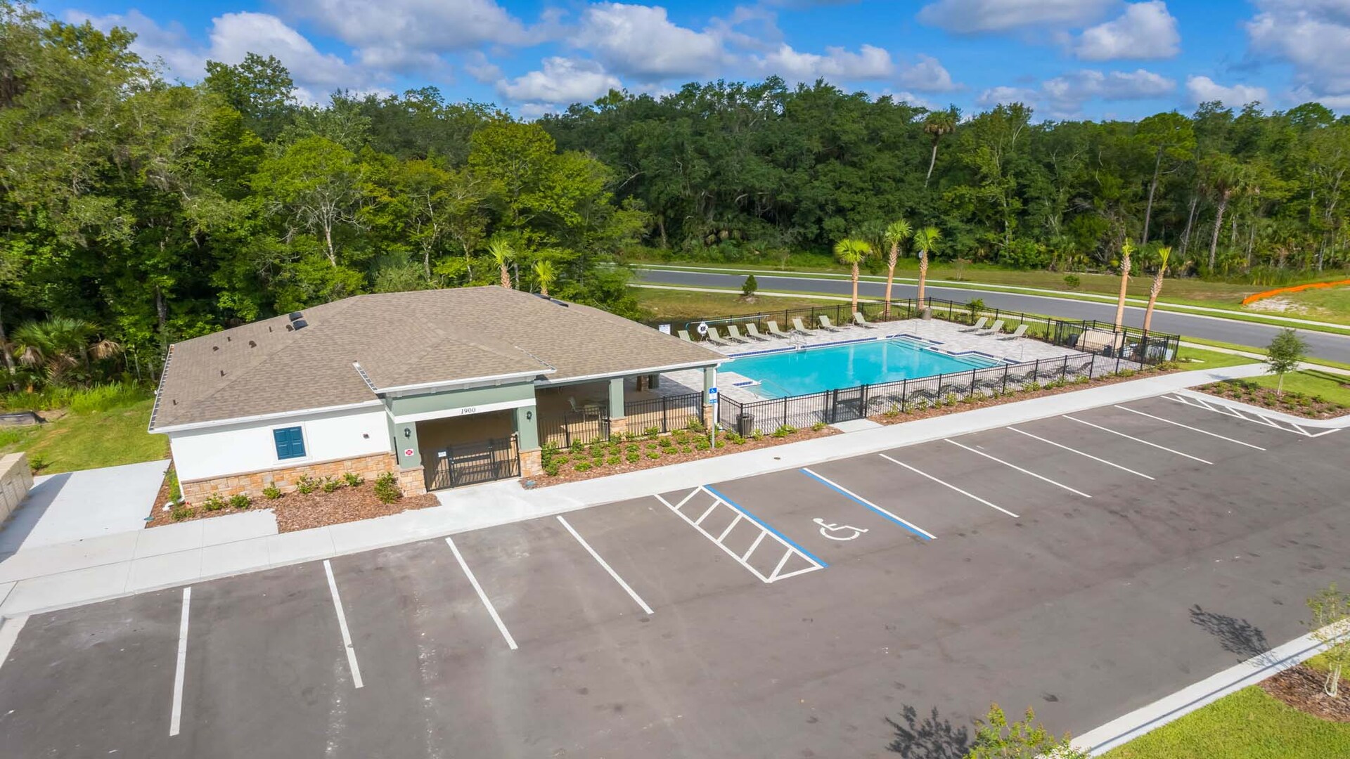 Sunny day at the community swimming pool with lounge seating.