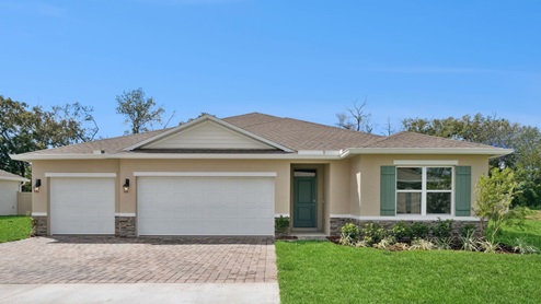 Single story new home with large windows and 3 car garage.