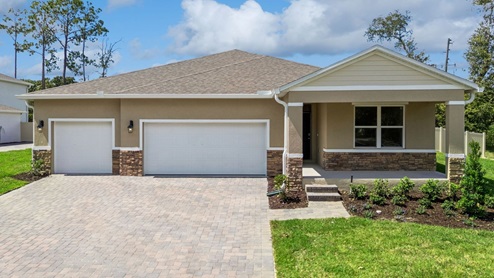 Single story new home with large windows and 3 car garage.