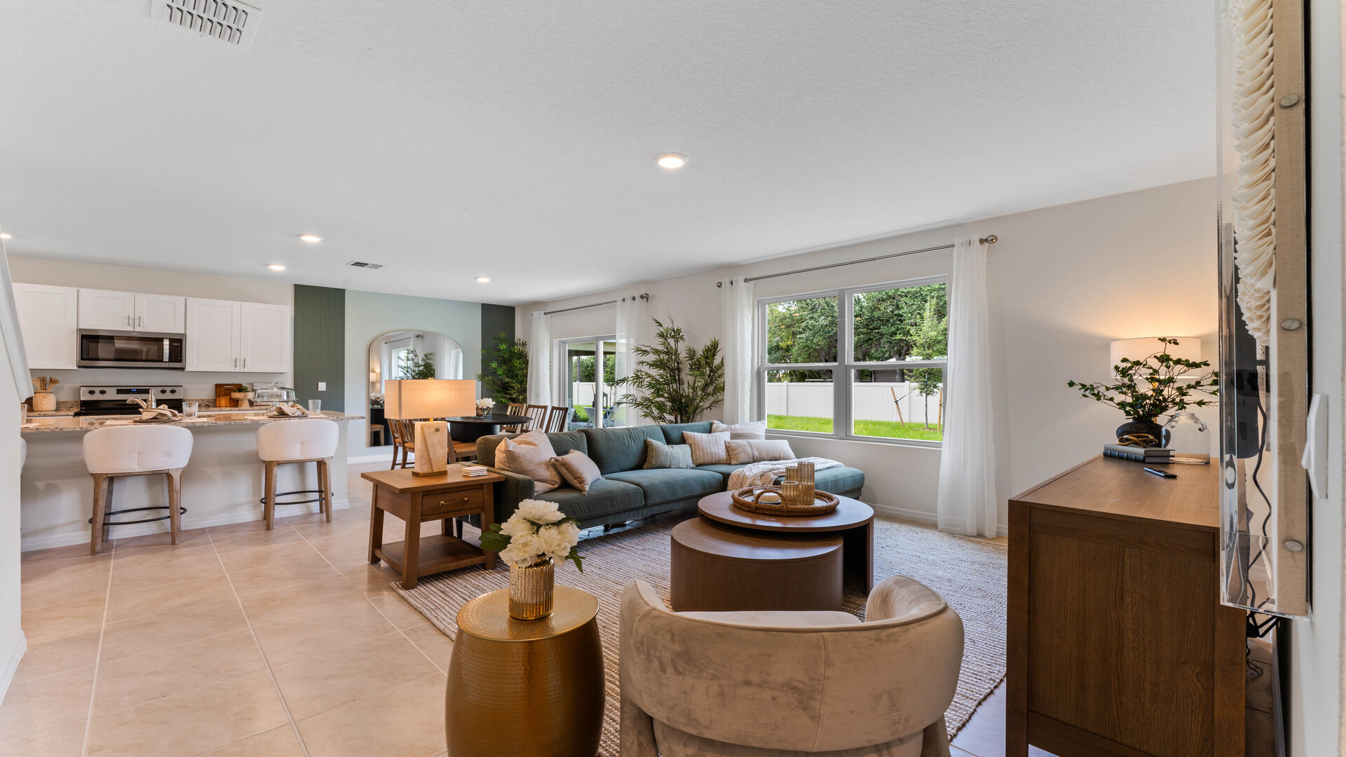 Open concept living area with couch seating and access to the backyard thru slider door.