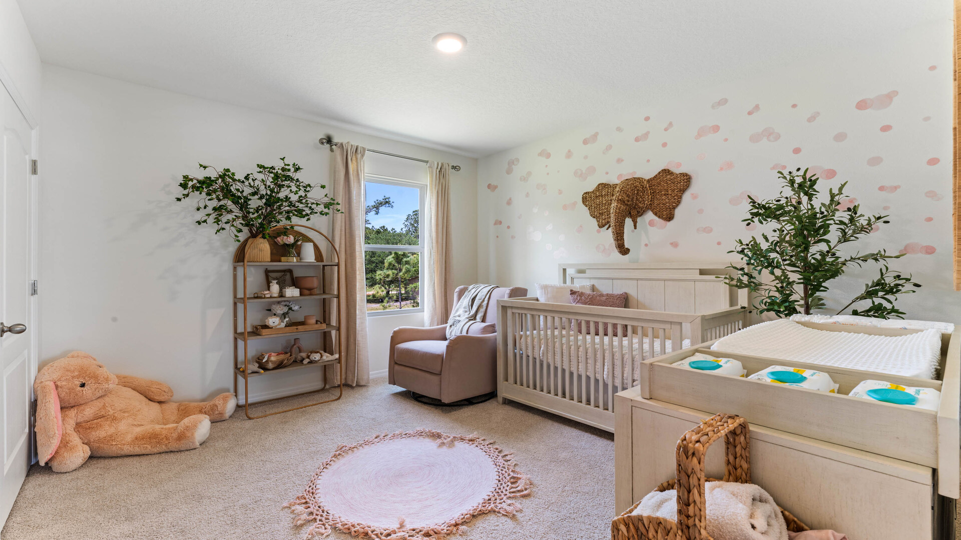 Child's nursery with crib, closet, soft seating and storage.