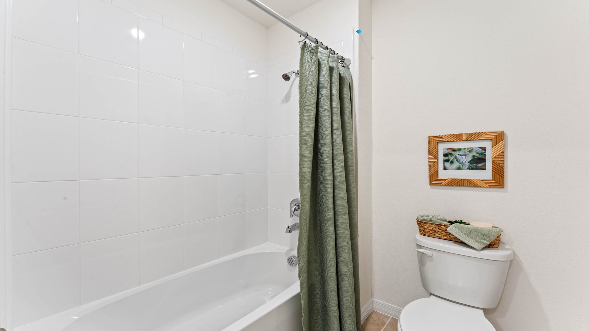 Modern bathroom with double vanity sinks, large wall mirror, cabinets and granite countertops.