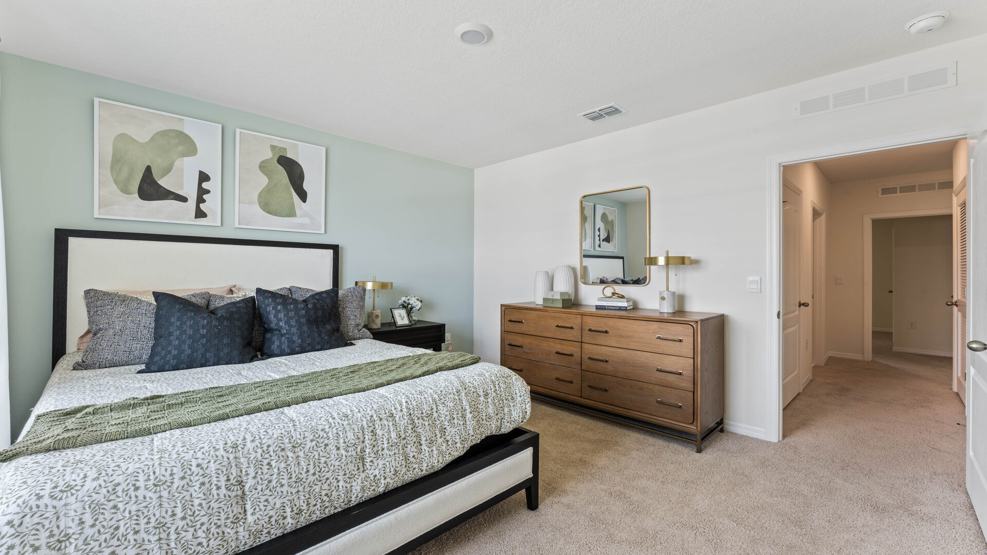 Guest bedroom with bed, nightstands and a roomy closet for storage.