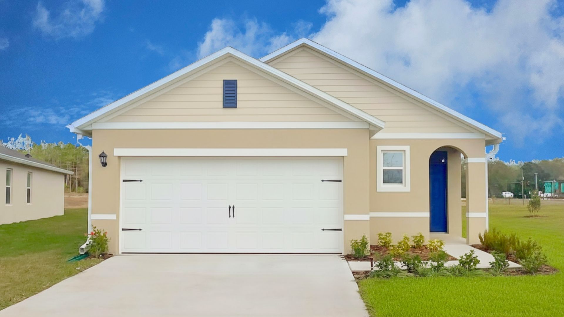 Single story new home with large windows and 2 car garage.