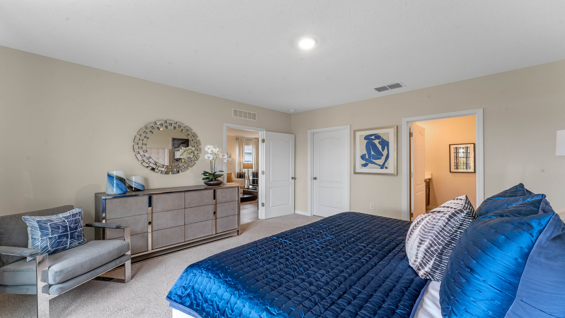 Guest bedroom with bed, nighstands and natural lighting.