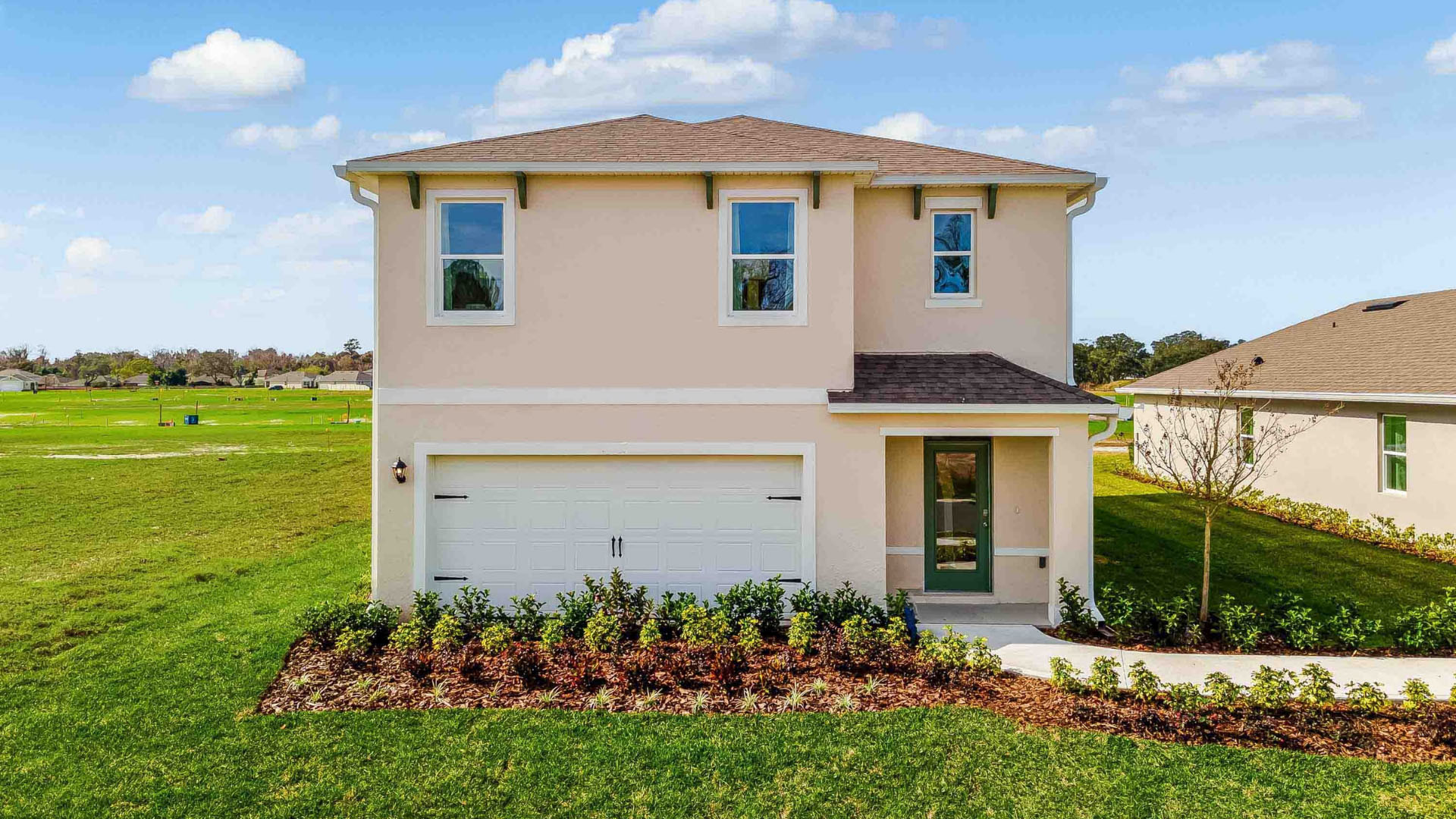 two story new home with large windows and 2 car garage.