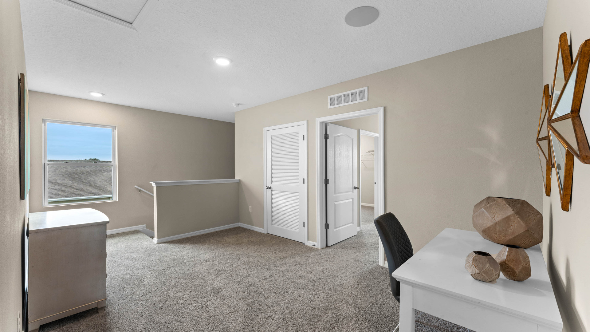 Living area with couch seating, entertainment system and natural lighting