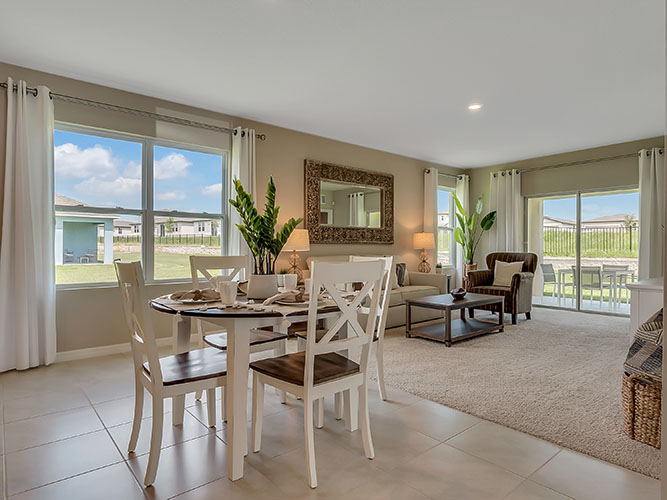 Dining room table with seating and natural lighting.