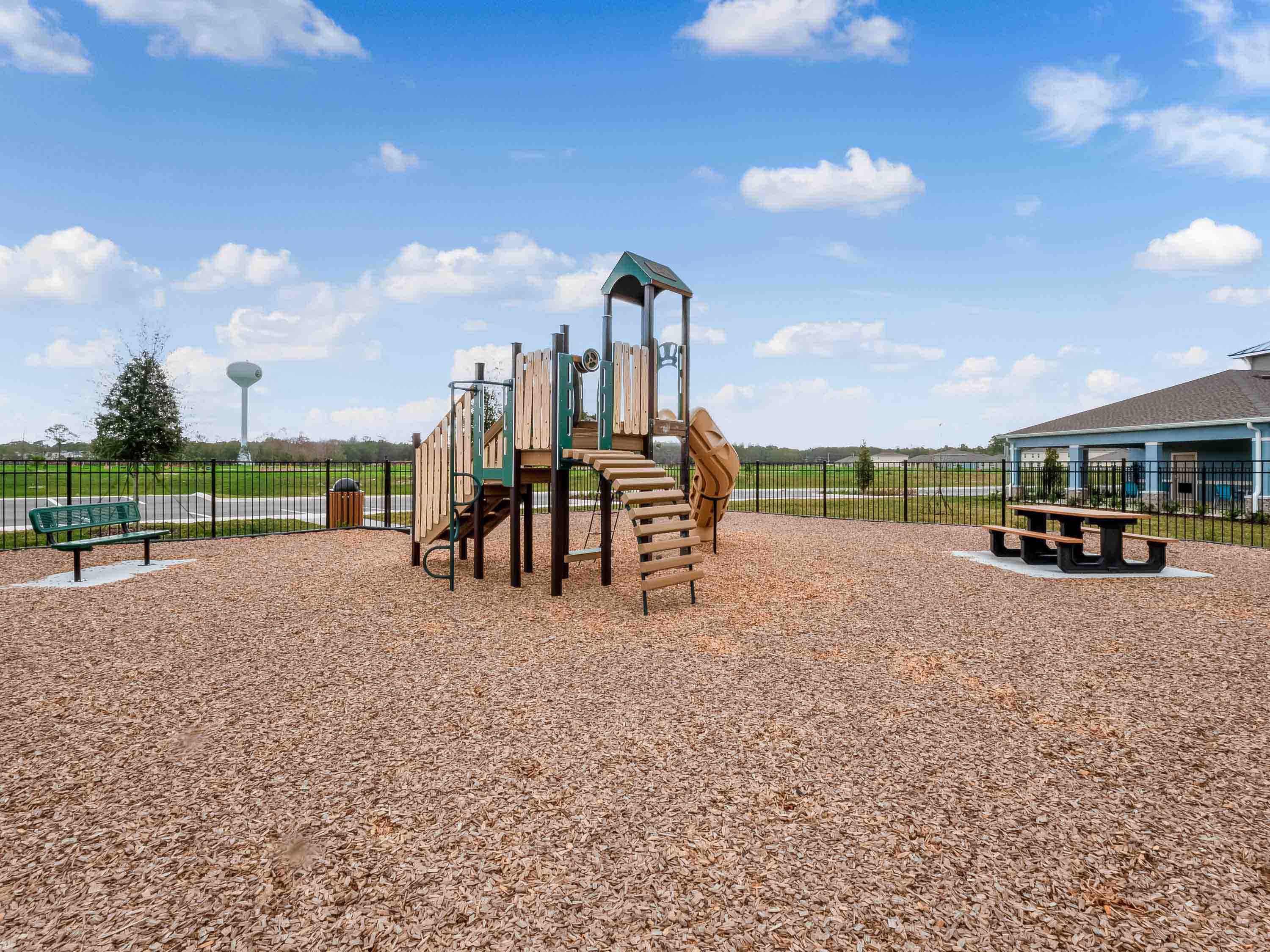 Kids outdoor playground with slide and swings.