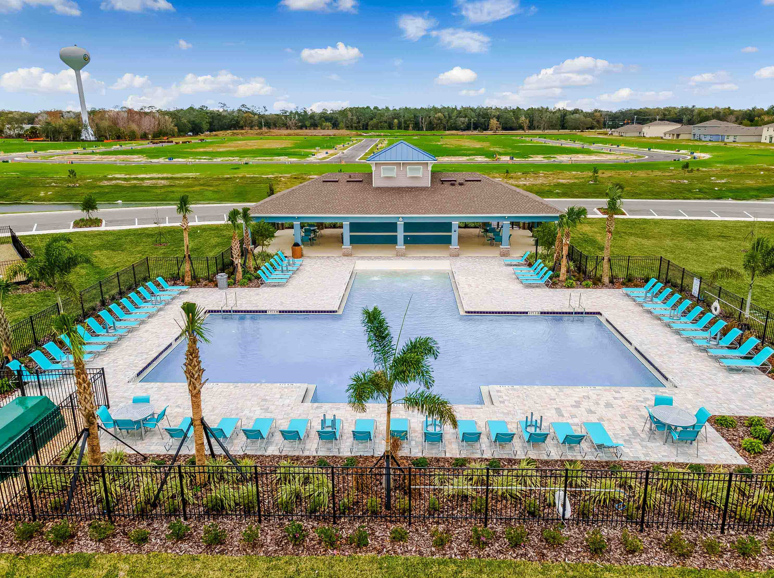 Sunny day at the community swimming pool with lounge seating.