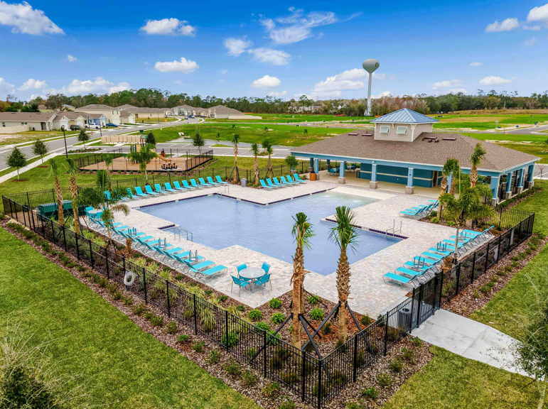 Cool off in the gated community pool, surrounded by lush landscaping