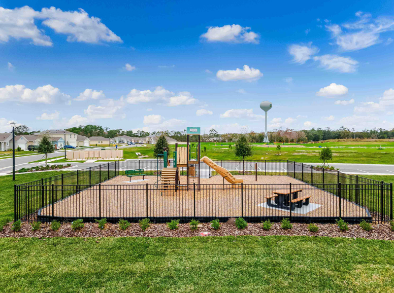 Fun children's playground with mulched ground and climbing equipment.