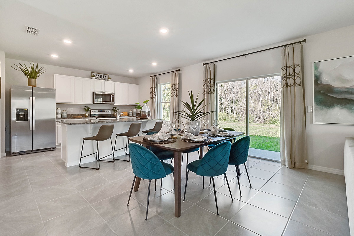 Dining room area with table, seating and natural lighting.