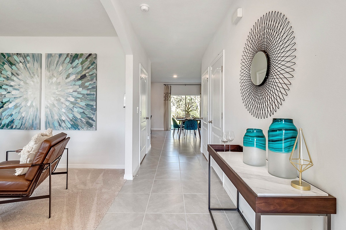 Home entry way thru the front door with tile flooring and front door.