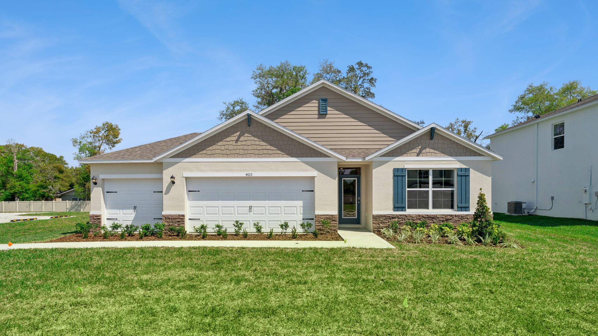 Single story new home with large windows and 2 car garage.