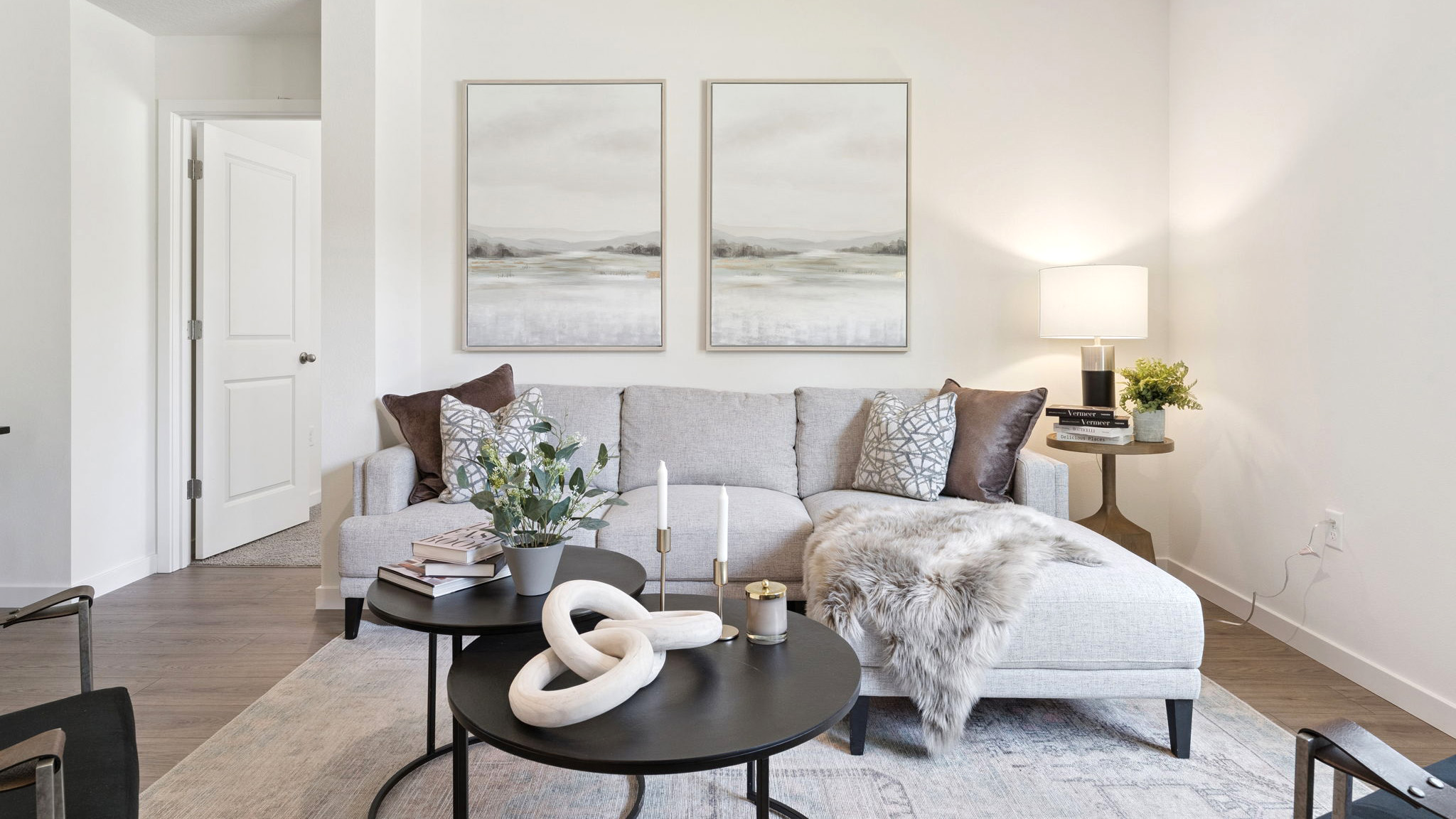 Living area with couch seating, entertainment system and natural lighting